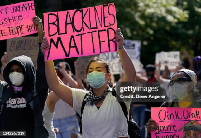 Protestor holding pink Black Lives Matters sign during Lafayette Park protest in 2020