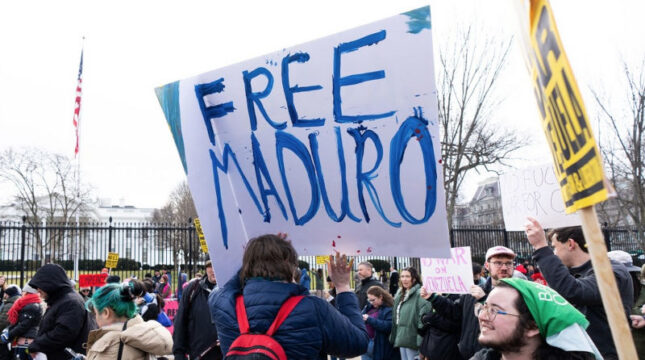 Man holding Free Maduro sign with blue writing in front of White House